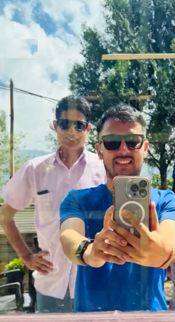Prem Sapkota taking a sunny outdoor selfie with a friend