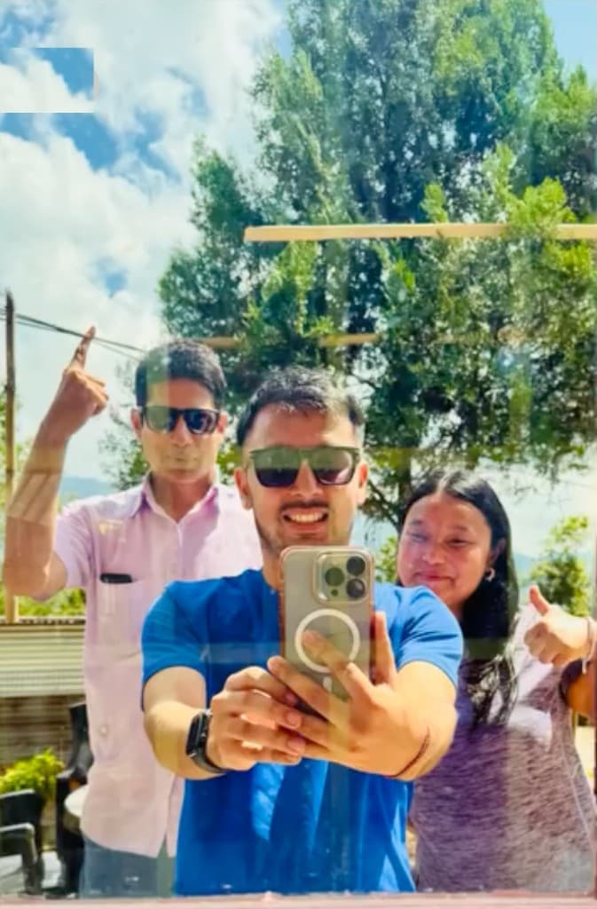 Prem Sapkota with friends taking a cheerful mirror selfie outdoors